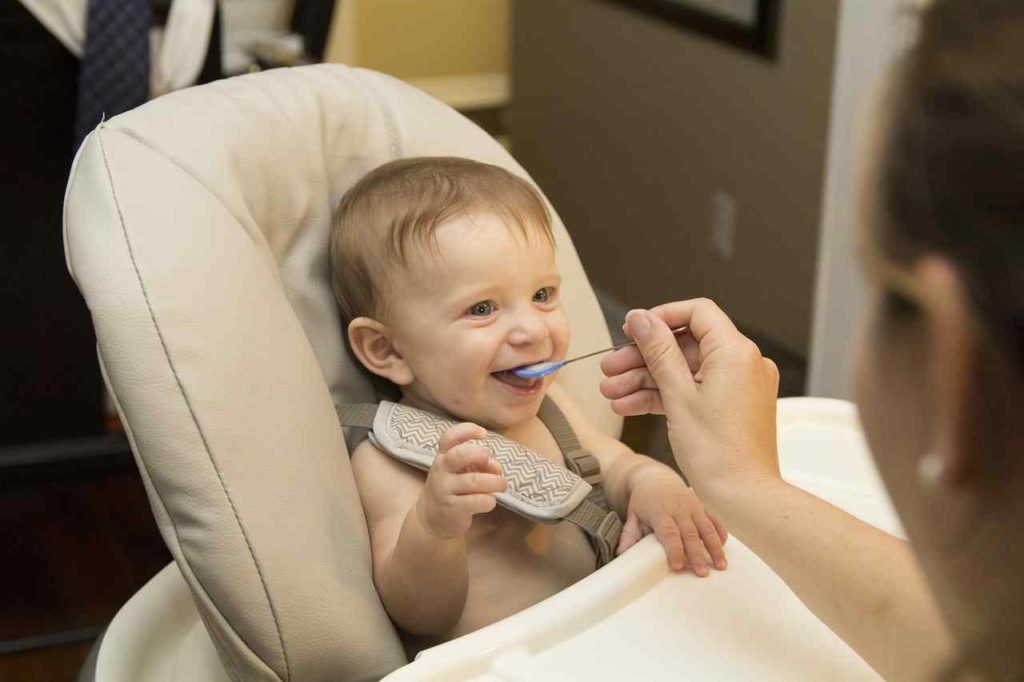 baby eating and smiling