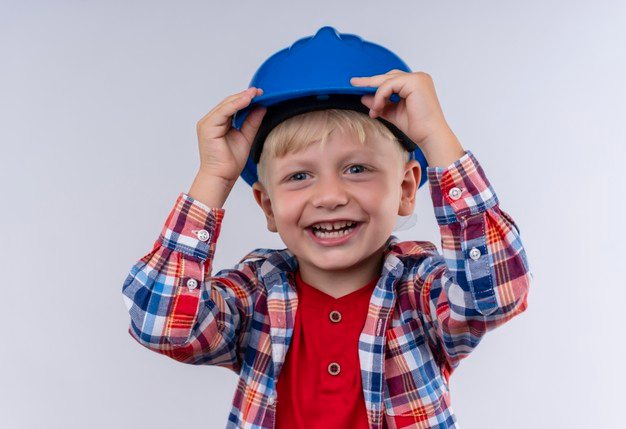 boy smiling and hold a cap